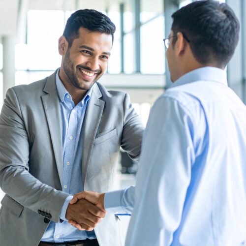 Firefly_-Two Indian businessmen in a modern office shaking hands and smiling, symbolizing a s 6918 (1) Firefly_-Two Indian businessmen in a modern office shaking hands and smiling, symbolizing a s 6918 (1)